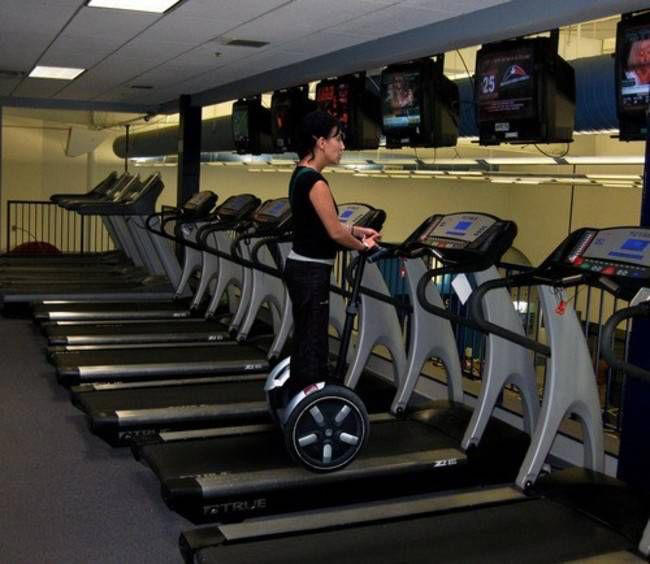 Reading the Newspaper on a Gym Machine, Man Using Gym Equipment Wrong, Guy Dressed Like Kill Bill at the Gym, Man Using an Exercise Ball in a Weird Way, Man Completely Confused by Gym Equipment, Man Reading the Newspaper, Old Lady Using Gym Machine Wrong, Guy Screaming While Exercising, Man Standing on Stacked Weights, Guy Bending Way Too Much While Lifting Weights, Woman Striking a Very Strange Pose, Weights on Her Back While on Her Phone, Woman Lying Down at the Gym Using Her Phone, Two-Wheel Scooter on a Treadmill, Woman Lying Down, Ignoring the Machine, Guy Carrying a Giant iPad on His Back, Full Cyclist Mode, Guy Eating at the Gym