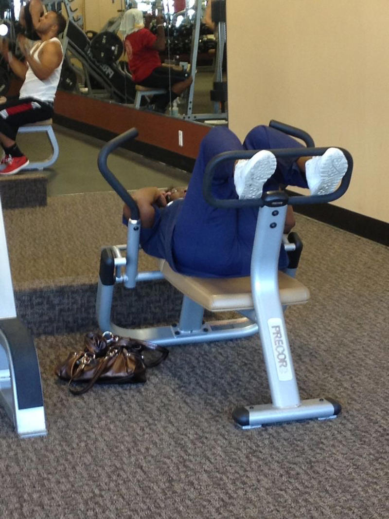 Reading the Newspaper on a Gym Machine, Man Using Gym Equipment Wrong, Guy Dressed Like Kill Bill at the Gym, Man Using an Exercise Ball in a Weird Way, Man Completely Confused by Gym Equipment, Man Reading the Newspaper, Old Lady Using Gym Machine Wrong, Guy Screaming While Exercising, Man Standing on Stacked Weights, Guy Bending Way Too Much While Lifting Weights, Woman Striking a Very Strange Pose, Weights on Her Back While on Her Phone, Woman Lying Down at the Gym Using Her Phone, Two-Wheel Scooter on a Treadmill, Woman Lying Down, Ignoring the Machine, Guy Carrying a Giant iPad on His Back, Full Cyclist Mode, Guy Eating at the Gym