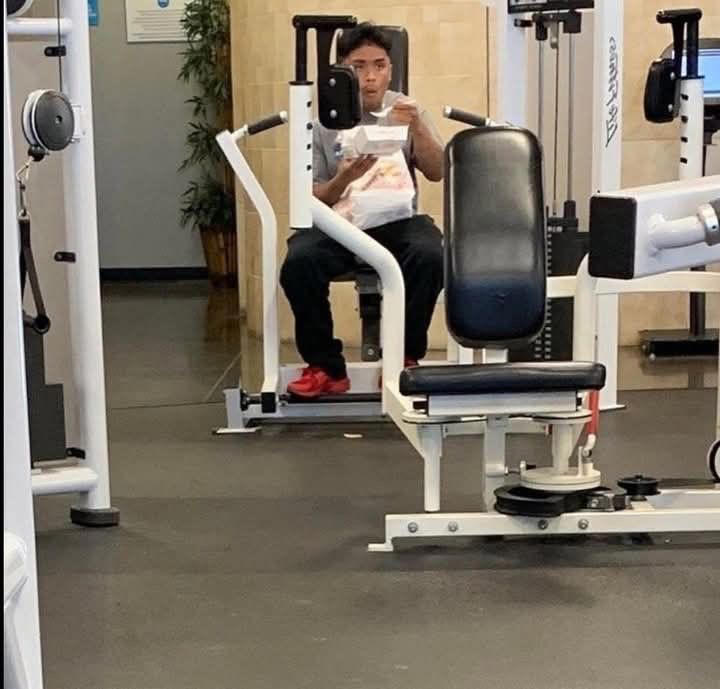 Reading the Newspaper on a Gym Machine, Man Using Gym Equipment Wrong, Guy Dressed Like Kill Bill at the Gym, Man Using an Exercise Ball in a Weird Way, Man Completely Confused by Gym Equipment, Man Reading the Newspaper, Old Lady Using Gym Machine Wrong, Guy Screaming While Exercising, Man Standing on Stacked Weights, Guy Bending Way Too Much While Lifting Weights, Woman Striking a Very Strange Pose, Weights on Her Back While on Her Phone, Woman Lying Down at the Gym Using Her Phone, Two-Wheel Scooter on a Treadmill, Woman Lying Down, Ignoring the Machine, Guy Carrying a Giant iPad on His Back, Full Cyclist Mode, Guy Eating at the Gym