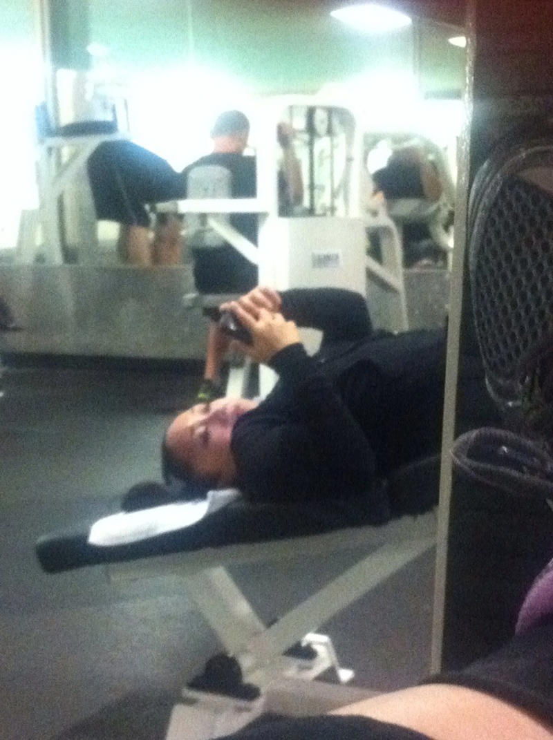 Reading the Newspaper on a Gym Machine, Man Using Gym Equipment Wrong, Guy Dressed Like Kill Bill at the Gym, Man Using an Exercise Ball in a Weird Way, Man Completely Confused by Gym Equipment, Man Reading the Newspaper, Old Lady Using Gym Machine Wrong, Guy Screaming While Exercising, Man Standing on Stacked Weights, Guy Bending Way Too Much While Lifting Weights, Woman Striking a Very Strange Pose, Weights on Her Back While on Her Phone, Woman Lying Down at the Gym Using Her Phone, Two-Wheel Scooter on a Treadmill, Woman Lying Down, Ignoring the Machine, Guy Carrying a Giant iPad on His Back, Full Cyclist Mode, Guy Eating at the Gym