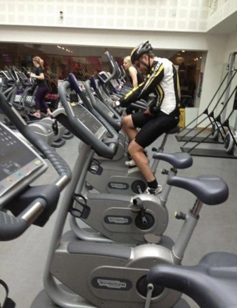 Reading the Newspaper on a Gym Machine, Man Using Gym Equipment Wrong, Guy Dressed Like Kill Bill at the Gym, Man Using an Exercise Ball in a Weird Way, Man Completely Confused by Gym Equipment, Man Reading the Newspaper, Old Lady Using Gym Machine Wrong, Guy Screaming While Exercising, Man Standing on Stacked Weights, Guy Bending Way Too Much While Lifting Weights, Woman Striking a Very Strange Pose, Weights on Her Back While on Her Phone, Woman Lying Down at the Gym Using Her Phone, Two-Wheel Scooter on a Treadmill, Woman Lying Down, Ignoring the Machine, Guy Carrying a Giant iPad on His Back, Full Cyclist Mode, Guy Eating at the Gym