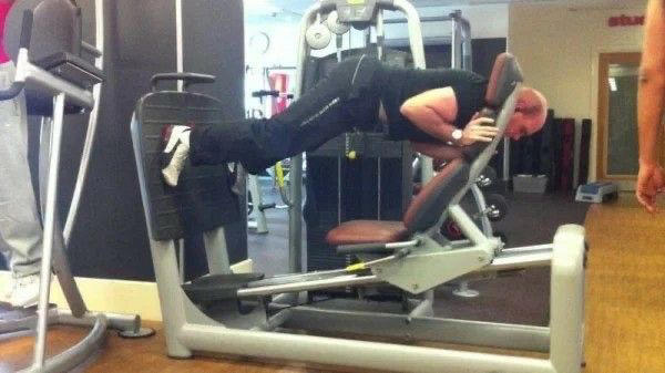 Reading the Newspaper on a Gym Machine, Man Using Gym Equipment Wrong, Guy Dressed Like Kill Bill at the Gym, Man Using an Exercise Ball in a Weird Way, Man Completely Confused by Gym Equipment, Man Reading the Newspaper, Old Lady Using Gym Machine Wrong, Guy Screaming While Exercising, Man Standing on Stacked Weights, Guy Bending Way Too Much While Lifting Weights, Woman Striking a Very Strange Pose, Weights on Her Back While on Her Phone, Woman Lying Down at the Gym Using Her Phone, Two-Wheel Scooter on a Treadmill, Woman Lying Down, Ignoring the Machine, Guy Carrying a Giant iPad on His Back, Full Cyclist Mode, Guy Eating at the Gym