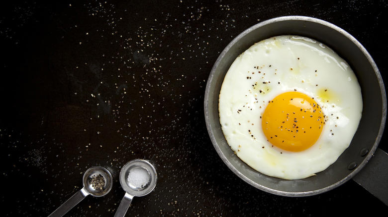Use a hot, lubricated pan to prevent sticking, For lacy, crispy edges, baste the eggs' edges with hot oil, Add water for fried eggs with tender, uncolored whites, Add buttery, toasty richness by frying eggs in cream, Here's how to get firm whites while keeping the yolk runny, Use room temperature eggs to ensure even frying, Add a splash of vinegar for a simple twist, To add extra crunch and flavor, fry eggs on shredded Parmesan, Cooking for a crowd? Fry your eggs in the oven