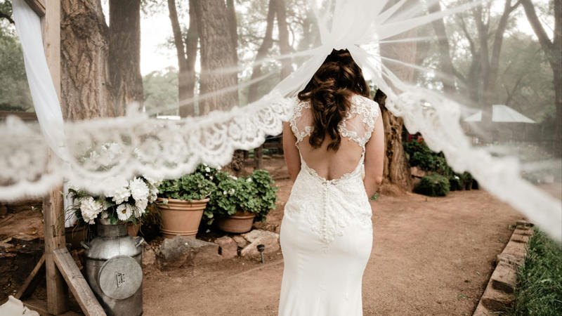11. Open-Back Stunner 1. Short and Chic, 2. Bridal Jumpsuit, 3. Two-Piece Set, 4. Colored Gown, 5. Black Bridal Look, 6. Cape Moment, 7. Detachable Overskirt, 8. Statement Sleeves, 9. High Neckline, 10. Deep V Drama, 11. Open-Back Stunner, 12. Sheer Illusion Details, 13. Corset Bodice, 14. Slip Dress, 15. Feather Accents, 16. Metallic Shine, 17. Floral 3D Appliqué, 18. Opt For The Tux, 19. Dramatic Train, 20. Vintage-Inspired Twist