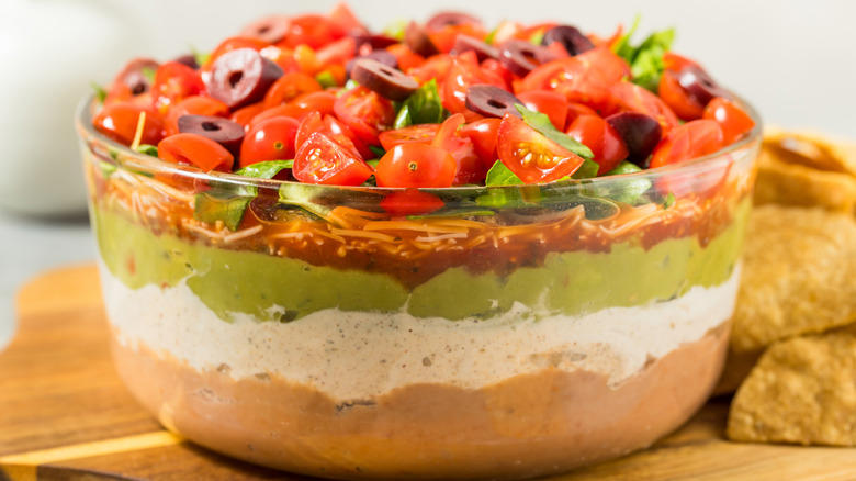 Shrimp cocktail, Molded Jell-O, Cabbage dumplings, French onion soup, Layered dips, Pasta salad, Arctic roll, Tuna noodle casserole, Deviled eggs