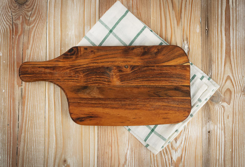 Use a damp napkin or towel to keep your cutting board in place.