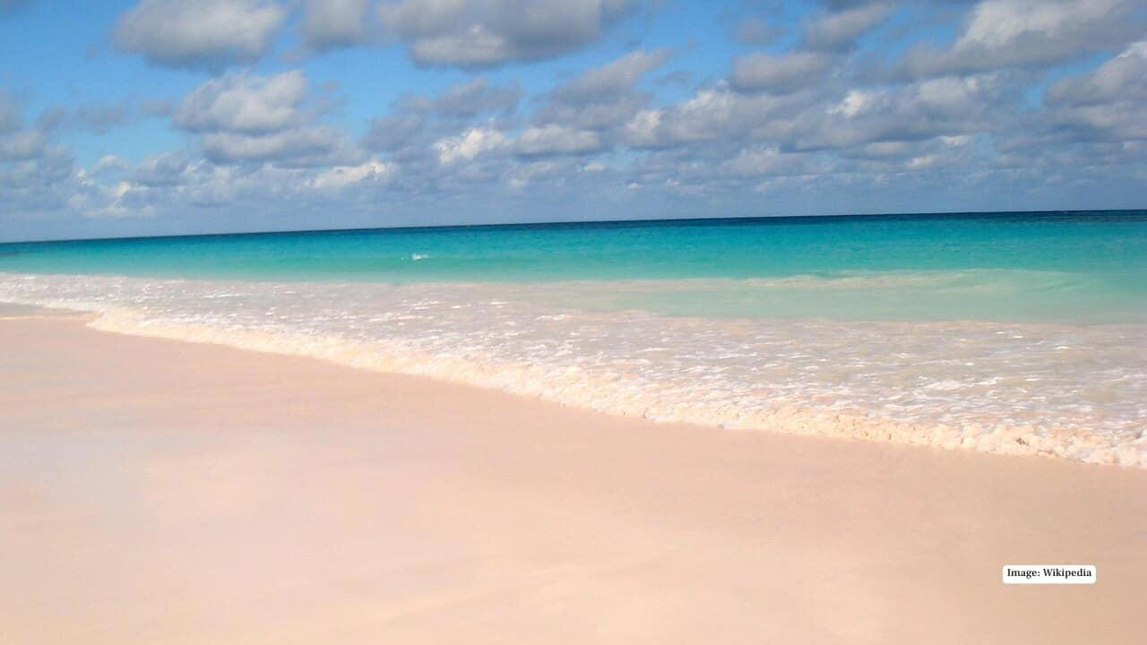 1. Bioluminescent Beach – Vaadhoo, Maldives At night, the waters around Vaadhoo Island glow like a galaxy of stars. Phytoplankton in the shallow lagoon emits light when disturbed, creating a mesmerizing “sea of stars” effect that feels truly otherworldly., 2. Pink Sands Beach – Harbour Island, Bahamas Soft, powdery pink sand stretches along this idyllic Caribbean island, tinted by microscopic organisms in the coral. The contrast with the turquoise waters makes it a photographer’s dream., 3. Whitehaven Beach – Queensland, Australia Renowned for 98% pure silica sand, Whitehaven Beach’s brilliant white shoreline swirls with clear turquoise waters at Hill Inlet. Its visual spectacle, ever-changing with tides, is simply hypnotic., 4. Diamond Beach – Iceland Near Jökulsárlón Glacier Lagoon, chunks of glacial ice scatter across black volcanic sand, sparkling like diamonds in the sunlight. The stark contrast between ice and dark sand creates a surreal Arctic scene., 5. Papakōlea Green Sand Beach – Big Island, Hawaii One of only four green sand beaches in the world, Papakōlea’s olive-colored sand comes from olivine crystals. Its remote location and striking color make it an unforgettable experience., 6. Reynisfjara Black Sand Beach – Iceland This dramatic beach is famous for its jet-black sand, powerful Atlantic waves, and towering basalt columns. A natural masterpiece of Icelandic geology, it’s both eerie and beautiful., 7. Hidden Beach – Marieta Islands, Mexico Also known as Playa del Amor, this secluded beach is hidden inside a volcanic crater. Accessible only through a water tunnel, it offers a private slice of paradise unlike any other., 8. Glass Beach – Fort Bragg, California Shimmering with smooth, multicolored sea glass, this beach was formed from decades of discarded glass polished by the ocean. Walking here feels like stepping on nature’s own gemstone collection., 9. Boulders Beach – Simon’s Town, South Africa Famous for its resident colony of African penguins, Boulders Beach combines giant granite boulders with secluded coves. It’s surreal not just in scenery but also in wildlife encounters., 10. Red Beach – Santorini, Greece Nestled against rust-colored volcanic cliffs, Red Beach’s terracotta-hued sand and clear blue waters create an iconic, almost painterly landscape. Its dramatic backdrop makes every sunset unforgettable.