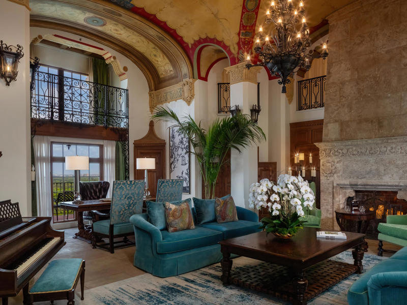 The Everglades Suite is often linked to Al Capone lore and was once the site of a mob killing. Today, the hotel is loved by high-profile figures., Inside, the hotel has kept its original, century-old lobby., The lobby decorations match the hotel's historic, elevated vibe., The lobby also serves as a dining area for afternoon tea., Downstairs, the hotel's Fontana restaurant partially sits in an open-air courtyard., Fontana serves Italian-inspired dishes., Brandi's, the hotel's dark, moody bar, draws inspiration from the Biltmore's past., At the 600-gallon pool, there's poolside dining and nine private cabanas., The Biltmore's clubhouse is the center of events at the property., Next to the course are spaces for relaxing and socializing., Tucked in the clubhouse, there's also a members-only lounge.