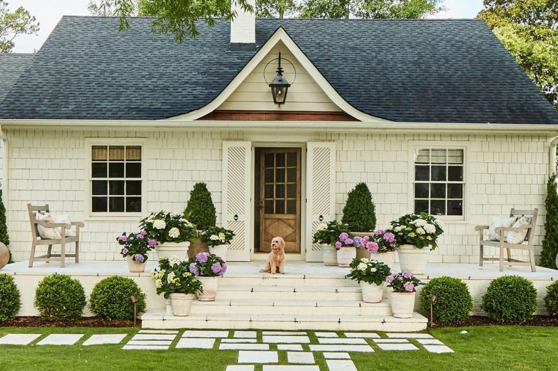 Why Curb Appeal Is Important, According To Experts, Add a Garden Path, Tidy Your Landscaping, Choose Plants That Thrive, Power-Wash Your Patio, Upgrade Your Garage Door, Flank Your Entry, Paint Strategically, Don’t Overlook Your Hardware, Opt for Architectural Lighting, Incorporate Natural Elements
