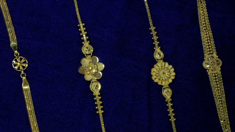 1. Classic Gold Hoop Earrings, 2. A Delicate Gold Chain Necklace, 3. Gold Stud Earrings, 4. A Gold Pendant Necklace, 5. A Gold Cuff Bracelet, 6. A Gold Signet Ring, 7. A Gold Layered Necklace Set, 8. A Gold Anklet, 9. A Gold Watch, 10. A Gold Chain Bracelet, 1. Sculptural Drop Earrings, 2. A Wide Gold Bangle, 3. A Gold Collar Necklace, 4. Statement Pearl-and-Gold Earrings, 5. A Chunky Gold Chain Necklace, 6. A Gold Cocktail Ring, 7. A Gold Brooch or Pin, 8. Gold Ear Cuffs, 9. A Two-Tone Gold Necklace, 10. A Gold Hair Accessory