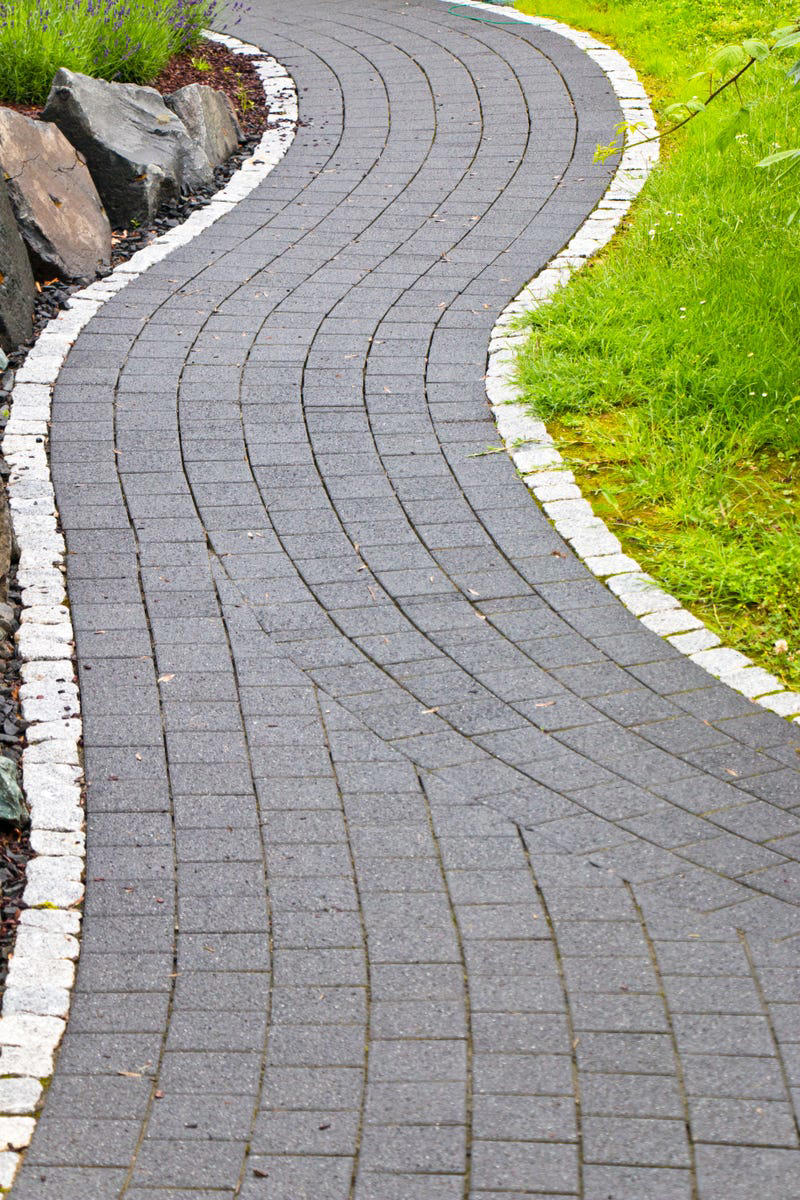 Why Edging Matters, Types of Edging, Free: Hand Edging, Almost Free: Glass Bottle Edging , Practically Free: Natural Log Edging, Inexpensive: Plastic Edging, Inexpensive: Woven Willow Edging, Inexpensive: Cedar Edging, Inexpensive: Landscape Timber Edging, Inexpensive: Bamboo Edging, Inexpensive: Pound-In Plastic Edging, Inexpensive: Metal Edging, Less Expensive: Scalloped Terracotta Edging, Less Expensive: Brick Edging, Less Expensive: Eucalyptus Wood Border Edging, Less Expensive: Grass and Shrub Edging, Less Expensive: Mixed Plant Edging,  Less Expensive: Gravel Edging, Less Expensive: Recycled Rubber Edging, Less Expensive: Stone and Gravel Edging, Less Expensive: Stone Pillar Edging , Moderately Expensive: Tidy Living Hedge Edging, Moderately Expensive: Weathering Steel Edging, Moderately Expensive: Paver Stone Edging, Moderately Expensive: Flagstone Edging, Expensive: Concrete Wall Edging, Expensive: Brick Wall Edging, Expensive: Decorative Fence Edging, Expensive: Raised-Garden Bed Edging, Expensive: Poured Concrete Edging, Various Prices: Natural Rock Edging, Various Prices: Antique Ironwork Border