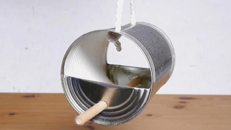 Repurpose a soup can into an adorable planter, Craft metal luminaries from empty soup cans, Transform a metal can into a unique bathroom vase, Make soup cans into chic, vintage-inspired desk organizers, Design a shabby chic carrying caddy from soup containers, Turn a ribbed can into a utensil crock, Decoupage metal cans into labeled pencil holders, Collect cans to make a wind chime, Hang a soup can as a basic bird feeder, Craft farmhouse decor with a smashed soup can, Transform a tin can into a nautical vase for coastal decor, Build a portable tool case out of metal cans, DIY an industrial wine rack from tin cylinders, Create festive tin can streamers