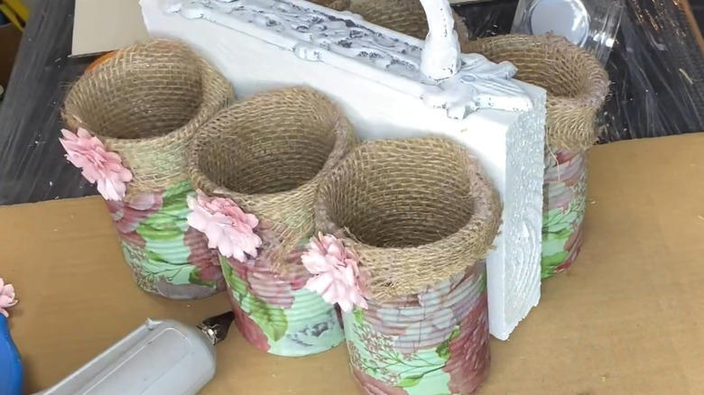 Repurpose a soup can into an adorable planter, Craft metal luminaries from empty soup cans, Transform a metal can into a unique bathroom vase, Make soup cans into chic, vintage-inspired desk organizers, Design a shabby chic carrying caddy from soup containers, Turn a ribbed can into a utensil crock, Decoupage metal cans into labeled pencil holders, Collect cans to make a wind chime, Hang a soup can as a basic bird feeder, Craft farmhouse decor with a smashed soup can, Transform a tin can into a nautical vase for coastal decor, Build a portable tool case out of metal cans, DIY an industrial wine rack from tin cylinders, Create festive tin can streamers