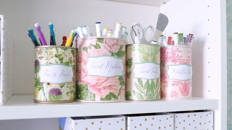 Repurpose a soup can into an adorable planter, Craft metal luminaries from empty soup cans, Transform a metal can into a unique bathroom vase, Make soup cans into chic, vintage-inspired desk organizers, Design a shabby chic carrying caddy from soup containers, Turn a ribbed can into a utensil crock, Decoupage metal cans into labeled pencil holders, Collect cans to make a wind chime, Hang a soup can as a basic bird feeder, Craft farmhouse decor with a smashed soup can, Transform a tin can into a nautical vase for coastal decor, Build a portable tool case out of metal cans, DIY an industrial wine rack from tin cylinders, Create festive tin can streamers