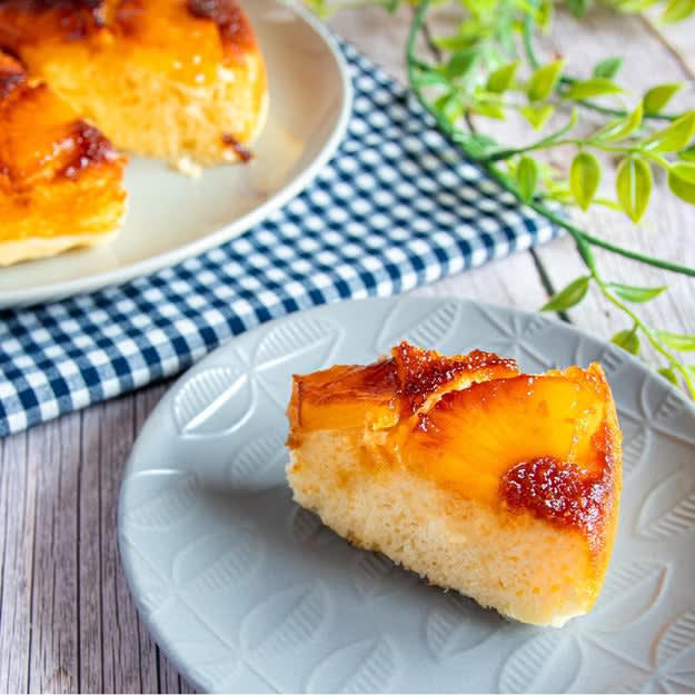 フライパンで簡単！ 「カラメルパイナップルケーキ」, レシピの基本情報：, ① ボウルに【A】を入れて混ぜ合わせる。, ② フライパンにグラニュー糖を入れて中火にかけ、カラメル色になったらバターを加えて混ぜる。パイナップルを敷き詰める。, ③ ①を流し入れ、ふたをして弱火で10分程焼く。お皿の上に裏返して置いたら、完成！