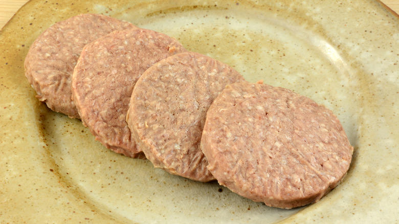 1. Add extra seasonings, 2. Don't skip the fresh toppings, 3. Add caramelized onions, 4. Glaze frozen burgers before grilling, 5. Melt compound butter over them, 6. Don't thaw frozen burgers first, 7. Make your own burger buns, 8. Add Worcestershire sauce, 9. Fry them in bacon grease, 10. Serve frozen burgers Salisbury steak-style