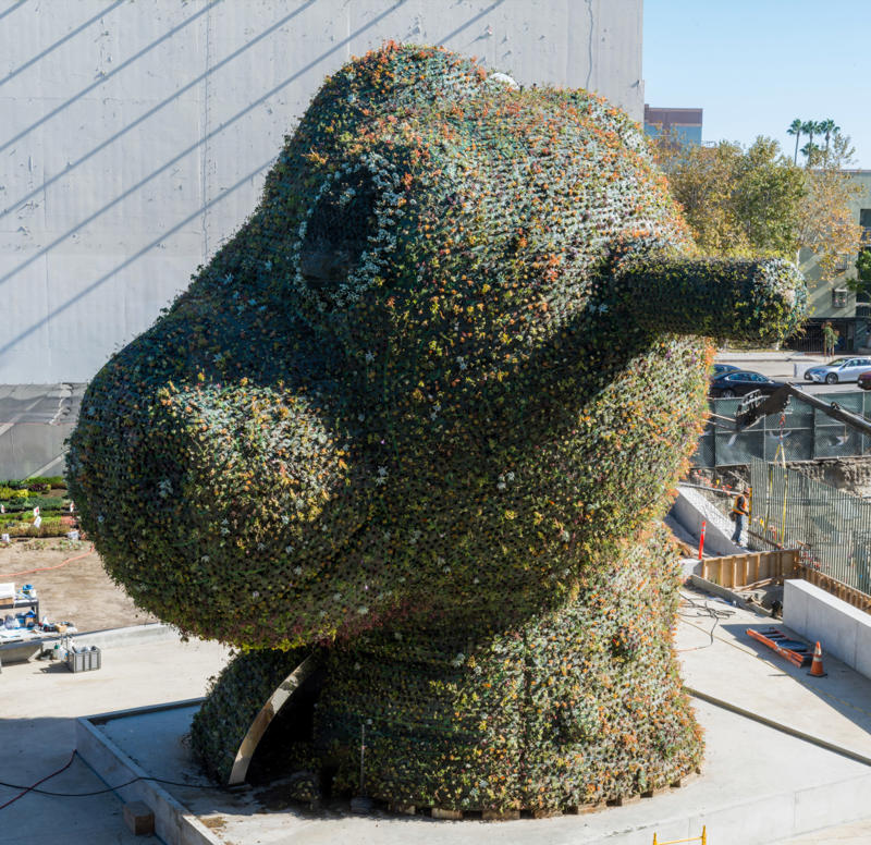 1. Jeff Koons, “Split-Rocker” (2000), 2. Artist Unknown, “Old Dog” (c. 200 B.C.–500 A.D.), 3. Duke Kahanamoku’s Surfboard (1920s), 4. Do Ho Suh, “Jagyeong Hall, Gyeongbok Palace” (2026), 5. Manjunath Kamath, “Vikatonarva” (2024), 6. Damascus Courtyard Home (c. 1766), 7. Maqsud Kashani, “Ardabil Carpet” (c. 1539), 8. Todd Gray, “Octavia’s Gaze” (2025), 9. Mariana Castillo Deball, “Feathered Changes” (2026), 10. Sarah Rosalena, “Threading the Boundless: Omnidirectional Terrain” (2025)