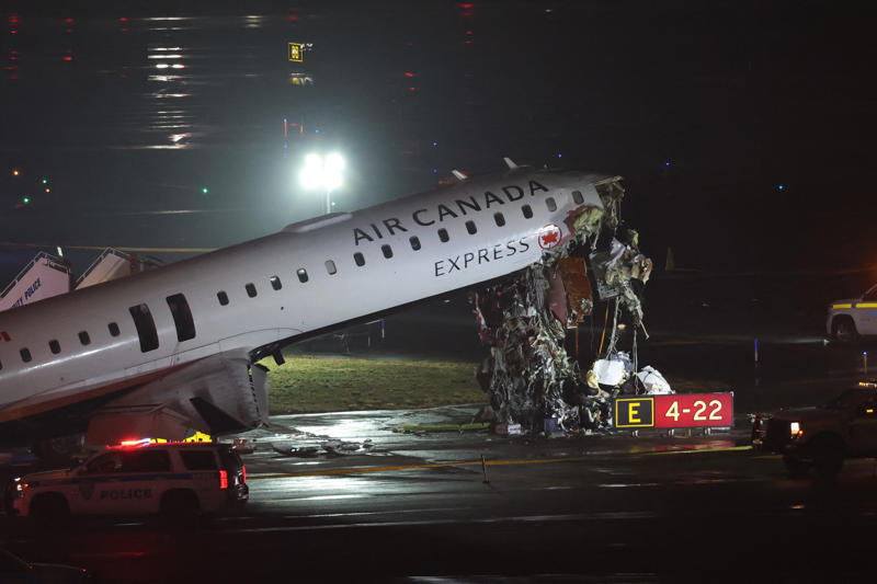 An Air Canada Express CRJ-900 sits on the runway after colliding with a Port Authority fire truck at LaGuardia Airport in New York, on March 23, 2026.