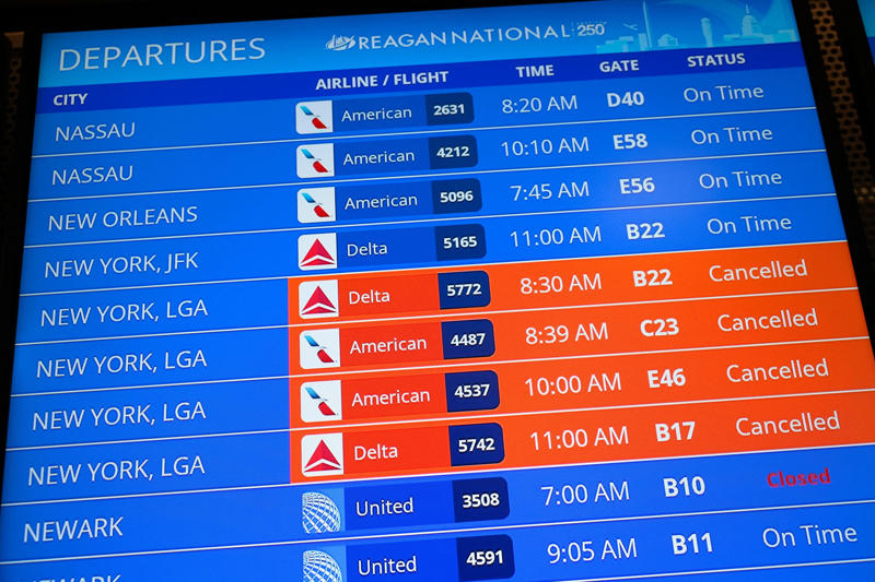 A screen at Ronald Reagan Washington National Airport shows canceled flights to New York's LaGuardia Airport after an Air Canada Express jet collided with a ground vehicle there, in Arlington, Va., March 23, 2026.