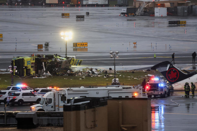 Emergency services work at the scene after an Air Canada Express jet collided with a ground vehicle at New York's LaGuardia Airport in Queens, New York, March 23, 2026.