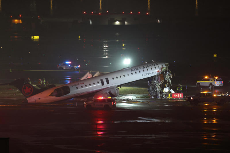 Emergency personnel respond to an Air Canada Express CRJ-900 that is sitting on the runway after colliding with a Port Authority fire truck at LaGuardia Airport in New York, on March 23, 2026. Air Canada Express flight AC8646 originated from Montreal and collided with the fire truck during landing.