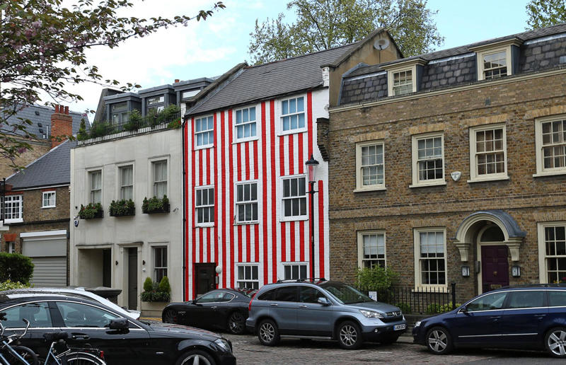 Woman gave house 'circus' makeover after planning complaints Surprising real estate spats from around the globe, Homeowner built fence through neighbour's swimming pool, Woman gave house 'circus' makeover after planning complaints, Ruffled residents take action against rowdy roosters, Man builds three-foot-wide house to block neighbour’s outlook, Goalkeeper took chainsaw to neighbour’s garage over obstructed view, Neighbours' tree cut in half over bird mess, Neighbours' tree cut in half over bird poo squabble, Millionaire couple sued by neighbours over supercar headache, Airbnb host riled neighbours with pink emoji paint job, Civil War veteran built skinny house to spite his brother, Vegan sued neighbours over barbecue smells, Neighbour filed noise complaint over rowdy sea lions, Disgruntled man listed part of homeowner's wall for £37k