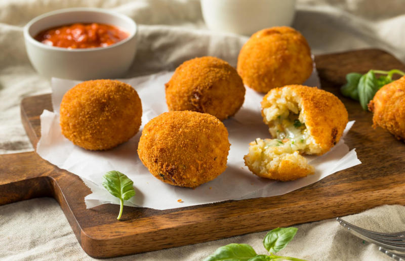 Turn leftover risotto into arancini Budget-friendly brilliance, Adopt the cucina povera mindset, Buy the best ingredients, Embrace simplicity, Never throw bread away, We repeat – never throw bread away, Stock your store cupboard, Savour your Parmesan, Make your own pasta mista, Try frittata di spaghetti, Turn leftover risotto into arancini, Grow your own, Turn vegetable scraps into pesto, Make good use of your pesto, Prepare a pan of minestrone, Get familiar with ribollita, Become a convert to sottaceti, Make your own giardiniera, Marinate your vegetables, Put your Bolognese to work, Transform cheese rinds into frico, Celebrate meat on the second day