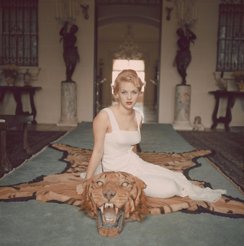 1940: A Glamorous Duo, 1946: A Beach Stroll, 1946: Under the Palm Trees, 1946: A Winter Getaway, 1948: A Fishing Trip, 1953: Street View, 1954: A Day at the Beach, 1955: A Slim Aarons Snapshot, 1955: Sketching by the Beach, 1955: Walking the Dog, 1955: Pretty in Pink, 1955: A Polo Ball, 1955: Worth Avenue, 1955: Evening Elegance, 1955: Luxury Living, 1955: Sipping Champagne, 1956: La Coquille Club, 1958: Glamorous in Chiffon, 1959: Sitting by the Pool, 1959: A Walk on the Wild Side, 1961: The Colony Hotel, 1961: A Pool Party, 1961: A Fashionable Affair, 1964: A Vibrant Duo, 1964: Lilly Pulitzer Designs, 1968: Athina Livanos Onassis, 1968: Outside the Flagler Museum, 1970: A Motorcycle Ride, 1970: A Painted Portrait in Palm Beach, 1970: Pretty Patterns, 1982: Picture-Perfect Palm Beach Home