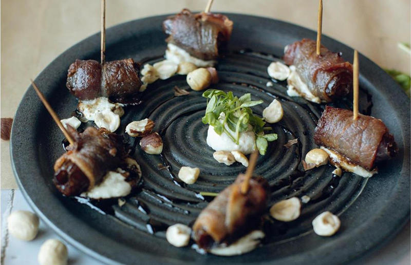 Utah: roasted bacon wrapped dates, Midway Mercantile Restaurant, Midway Bacon with EVERYTHING, Alabama: BALT, Urban Cookhouse, various locations, Alaska: Fat Elvis milkshake, Snow City Cafe, Anchorage, Arizona: stuffed Medjool dates, J.T. Prime Kitchen & Cocktails, Yuma, Arkansas: Eggniter, Golden Kolache Bakery, Fayetteville, California: B’B’B’ Bacon, Slater's 50/50, various locations, Colorado: signature bacon flight, Bacon Social House, various locations, Connecticut: smoked mac & cheese, Pig Rig BBQ, Wallingford, Delaware: bacon cheese fries, m2o Burgers & Salads, Newark, District of Columbia: glazed bacon lollis, Founding Farmers, various locations, Florida: candied bacon maple ice cream, Ulele, Tampa, Georgia: BBQ bacon, Burger 21, Kennesaw and Buford, Hawaii: Fat Boy, Hank's Haute Dogs, Honolulu, Idaho: bacon, egg, and cheese breakfast tacos, Tin Roof Tacos, various locations, Illinois: cheeseburger, Au Cheval, Chicago, Indiana: BLT croissant, Rize, various locations, Iowa: pancake sandwich, The Breakfast Club, various locations, Kansas: bleu cheese and bacon burger, The Anchor, Wichita, Kentucky: maple bacon donut, Nord's Bakery, Louisville, Louisiana: Buckboard Bacon Melt, Cochon Butcher, New Orleans, Maine: bacon Cheddar, The Holy Donut, Portland, Maryland: Baltimore Burger, Abbey Burger Bistro, Baltimore and Havre de Grace, Massachusetts: 'Irish' nachos, Harry's Bar & Grill, Boston, Michigan: BLT, Tony’s I-75, Birch Run, Minnesota: Millionaire bacon burger, Granite City Food & Brewery, various locations, Mississippi: Redneck Benny, Big Bad Breakfast, Oxford, Missouri: The Combo, Songbird, St. Louis, Montana: The 'Mazatlan' Mexican Dog, The Burger Dive, Billings, Nebraska: Greatest Burger Ever, Honest Abe’s Burgers & Freedom, Lincoln, Nebraska, Nevada: 24K Burger, Slater's 50/50, Las Vegas, New Hampshire: Bacon Bene, The Bacon Barn, Londonderry, New Jersey: bacon brisket sandwich, Bake'n Bacon, Cape May, New Mexico: BB&C, Urban Hotdog Company, Albuquerque, New York: Clothesline Bacon, David Burke Tavern, New York City, North Carolina: BLT, Merritt's Grill, Chapel Hill, North Dakota: The Elvis, Bearscat Bakehouse, Bismarck and Minot, Ohio: Biscuit BLT, Dough Mama, Columbus, Oklahoma: Brussels sprouts, Packard’s, Oklahoma City, Oregon: praline bacon, Screen Door, Portland, Pennsylvania: bacon flight, Bacon, Bourbon & Beer, Washington, Rhode Island: BLT, The Malted Barley, Providence, South Carolina: candied bacon brownie, Nose Dive, Greenville, South Dakota: bacon wrapped filet mignon, Alpine Inn, Hill City, Tennessee: Southern Sampler Breakfast, The Loveless Cafe, Nashville, Texas: chicken fried bacon, Sodolak's Original Country Inn, Snook, Utah: roasted bacon wrapped dates, Midway Mercantile Restaurant, Midway, Vermont: Breakfast Mac, Our House Bistro, Winooski, Virginia: Mother Clucker, Capitol Waffle Shop, various locations, Washington: Meatza, Windy City Pie, Seattle, West Virginia: hot chicken sandwich with bacon, Wood Iron Eatery, Fayetteville, Wisconsin: tequila jam burger, 11:11 Burgers & Beignets, Fond Du Lac, Wisconsin
