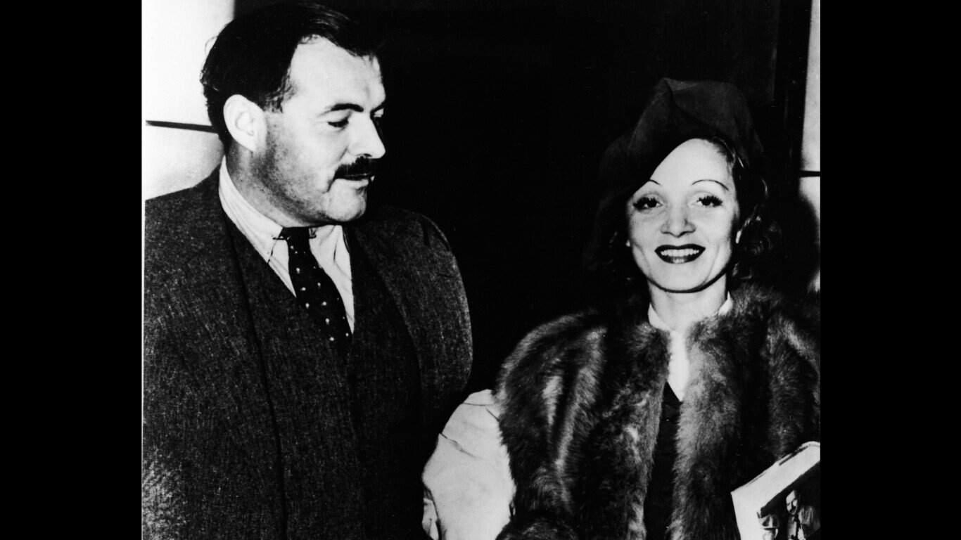 3. Ernest Hemingway and Marlene Dietrich 1. Three models with hats by Hélène Sorbier, 2. People celebrating New Year’s Eve at El Morocco in New York City, 3. Ernest Hemingway and Marlene Dietrich, 4. Three women modeling dresses by Marcelle Landowska, 5. Lady smiling for a portrait, 6. Family of four listening to the radio, 7. German film director Fritz Lang, 9. Stepping out for a spring fashion parade in Brisbane, Australia, 10. Jean Harlow with Marcel Waves, 11. Conductors Serge Koussevitsky (left) and Sir Thomas Beecham, 12. Models with an audience in Paris, 13. American cartoonist and fashion designer Gladys Parker, 14. Three women with hats in Paris, 15. Golfer Bobby Jones (right) with the Walker Cup in Sandwich, England, 16. Models posing for a fashion shoot, 17. Modeling dresses by Hélène Sorbier in Paris, 18. German industrialist and arms manufacturer Gustav Krupp von Bohlen und Halbach (second from right) with his extended family, 19. A model in Paris, 20. Louisiana governor and senator Huey Long at a radio broadcast, 21. Brazilian politician Getúlio Vargas, 22. A model at the House of Paquin in Paris, 23. Two models in suits in Paris, 24. Austrian doctor and psychotherapist Alfred Adler, 25. Boxer Jack Dempsey, 26. British politician James Thomas (center) and friends, 27. Posing outside a cat show at the Salle Wagram, Paris, 28. Miss France, 29. Attorney Clarence Darrow (right), 30. Model De Decker with hat, 31. Actresses Laurette Taylor (left) and Ethel Barrymore, 32. Model De Decker with another hat, 33. Two models with hats in Paris, 34. Model Eliane Richer with hat, 35. Austrian-born actor and director Erich Von Stroheim, 36. Model Hélène Sorbier with hat, 37. Douglas Fairbanks Jr. (left), Charlie Chaplin, and Mary Pickford, 38. Fashion models, 39. Model in long dress with hat, 40. Models in a Red Bug Electric Roadster car at the Edison Electrical Exposition in New York, 41. Model with a hat, 42. Gary Cooper (right) and a location caterer on the set of “The Spoilers”, 43. A reception for golfer Bobby Jones after his British Open victory, 44. Model in a dress, 45. British photographer and costume designer Cecil Beaton, 46. Business mogul and multimillionaire John D. Rockefeller, 47. Five college girls jumping in winter clothes, 48. Model Hélène Sorbier with hat, 49. Model in a summer dress with hat, 50. Businessman and philanthropist Simon Guggenheim, 51. Diplomats from Czechoslovakia, Romania, and Yugoslavia at a Little Entente conference in Belgrade, 52. Model with a hat in Paris, 53. Woman standing outside