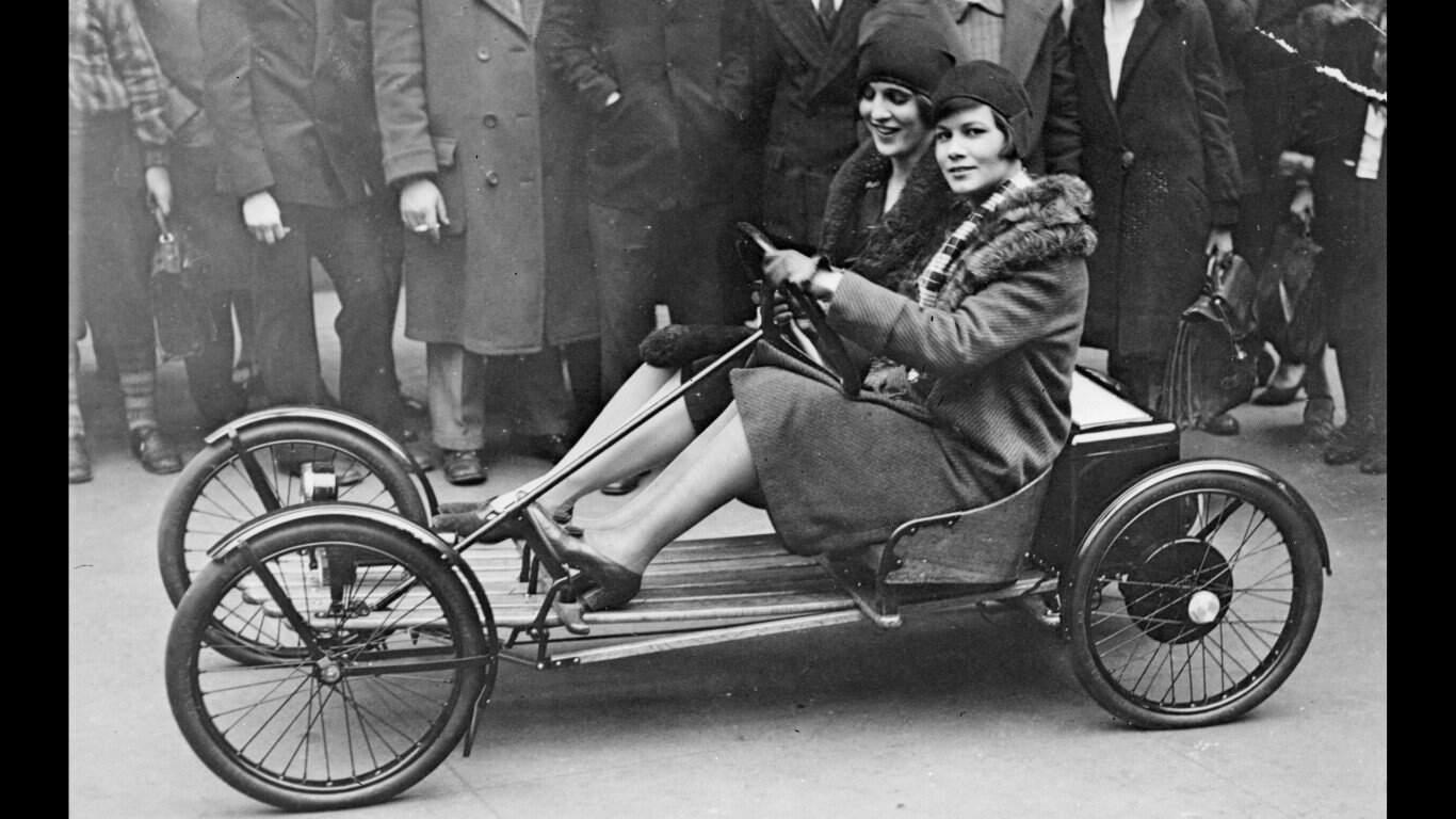 40. Models in a Red Bug Electric Roadster car at the Edison Electrical Exposition in New York 1. Three models with hats by Hélène Sorbier, 2. People celebrating New Year’s Eve at El Morocco in New York City, 3. Ernest Hemingway and Marlene Dietrich, 4. Three women modeling dresses by Marcelle Landowska, 5. Lady smiling for a portrait, 6. Family of four listening to the radio, 7. German film director Fritz Lang, 9. Stepping out for a spring fashion parade in Brisbane, Australia, 10. Jean Harlow with Marcel Waves, 11. Conductors Serge Koussevitsky (left) and Sir Thomas Beecham, 12. Models with an audience in Paris, 13. American cartoonist and fashion designer Gladys Parker, 14. Three women with hats in Paris, 15. Golfer Bobby Jones (right) with the Walker Cup in Sandwich, England, 16. Models posing for a fashion shoot, 17. Modeling dresses by Hélène Sorbier in Paris, 18. German industrialist and arms manufacturer Gustav Krupp von Bohlen und Halbach (second from right) with his extended family, 19. A model in Paris, 20. Louisiana governor and senator Huey Long at a radio broadcast, 21. Brazilian politician Getúlio Vargas, 22. A model at the House of Paquin in Paris, 23. Two models in suits in Paris, 24. Austrian doctor and psychotherapist Alfred Adler, 25. Boxer Jack Dempsey, 26. British politician James Thomas (center) and friends, 27. Posing outside a cat show at the Salle Wagram, Paris, 28. Miss France, 29. Attorney Clarence Darrow (right), 30. Model De Decker with hat, 31. Actresses Laurette Taylor (left) and Ethel Barrymore, 32. Model De Decker with another hat, 33. Two models with hats in Paris, 34. Model Eliane Richer with hat, 35. Austrian-born actor and director Erich Von Stroheim, 36. Model Hélène Sorbier with hat, 37. Douglas Fairbanks Jr. (left), Charlie Chaplin, and Mary Pickford, 38. Fashion models, 39. Model in long dress with hat, 40. Models in a Red Bug Electric Roadster car at the Edison Electrical Exposition in New York, 41. Model with a hat, 42. Gary Cooper (right) and a location caterer on the set of “The Spoilers”, 43. A reception for golfer Bobby Jones after his British Open victory, 44. Model in a dress, 45. British photographer and costume designer Cecil Beaton, 46. Business mogul and multimillionaire John D. Rockefeller, 47. Five college girls jumping in winter clothes, 48. Model Hélène Sorbier with hat, 49. Model in a summer dress with hat, 50. Businessman and philanthropist Simon Guggenheim, 51. Diplomats from Czechoslovakia, Romania, and Yugoslavia at a Little Entente conference in Belgrade, 52. Model with a hat in Paris, 53. Woman standing outside