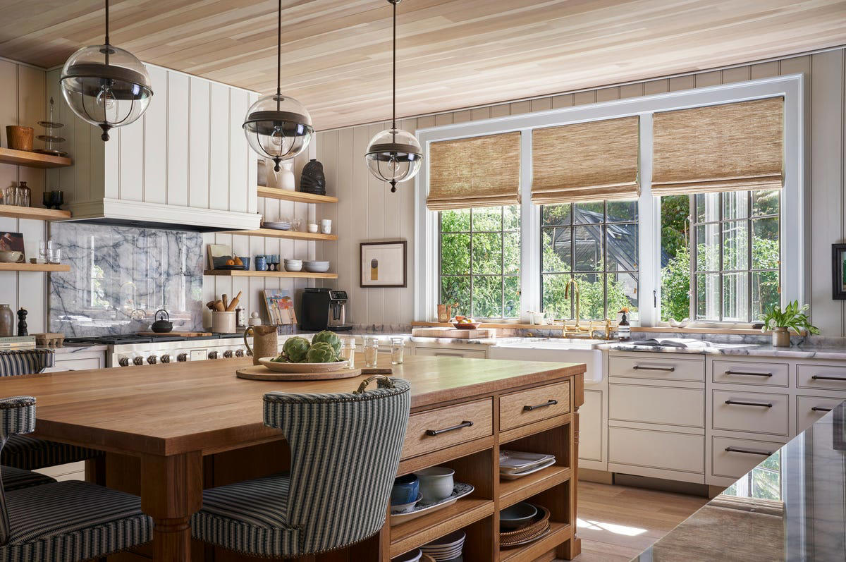 Sign #1: Knotty Pine or Orange Oak Cabinetry, Sign #2: Closed-Off Spaces, Sign #3: Quirky Decorative Details , Sign #4: High Barstools and Countertops, Sign #5: Upper Cabinetry, Sign #6: Dropped Ceilings With Fluorescent Lighting, Sign #7: Not Enough Counter Space, Sign #8: Having a Visible Microwave, Sign #9: Tiled Backsplashes, Sign #10: Granite Countertops , Sign #11: Laminate or Tile Countertops, Sign #12: All-White Shaker Cabinets, Sign #13: Word Signs, Sign #14: Oversized Can Lights, Sign #15: Outdated hardware and fixtures, Sign #16: Hanging Pot Racks, Sign #17: Intentionally Distressed Cabinets, Sign #18: Lack of Integrated Appliances, Sign #19: Having a Homemaker's Desk, Sign #20: “Hearth-Style” Vent Hoods, Sign #21: Traditional Dining Areas, Sign #22: Lack of Cohesive Materials