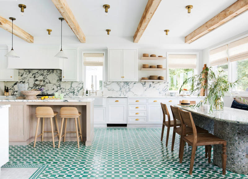 Sign #1: Knotty Pine or Orange Oak Cabinetry, Sign #2: Closed-Off Spaces, Sign #3: Quirky Decorative Details , Sign #4: High Barstools and Countertops, Sign #5: Upper Cabinetry, Sign #6: Dropped Ceilings With Fluorescent Lighting, Sign #7: Not Enough Counter Space, Sign #8: Having a Visible Microwave, Sign #9: Tiled Backsplashes, Sign #10: Granite Countertops , Sign #11: Laminate or Tile Countertops, Sign #12: All-White Shaker Cabinets, Sign #13: Word Signs, Sign #14: Oversized Can Lights, Sign #15: Outdated hardware and fixtures, Sign #16: Hanging Pot Racks, Sign #17: Intentionally Distressed Cabinets, Sign #18: Lack of Integrated Appliances, Sign #19: Having a Homemaker's Desk, Sign #20: “Hearth-Style” Vent Hoods, Sign #21: Traditional Dining Areas, Sign #22: Lack of Cohesive Materials