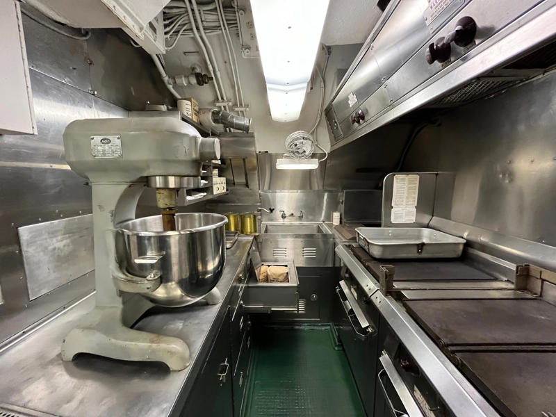 Meals were prepared in the galley. In the navigation compartment, crew members plotted courses and tracked Growler's position., The missile checkout and guidance center was once a top-secret area., Officers had access to their own shower., Officers used the wardroom to eat, socialize, and hold meetings., Yeomen handled clerical and administrative work aboard the USS Growler's tiny office., Here, the commanding officer would give orders to the crew., The sonar room also aided Growler's navigation., Crew members communicated with other ships in the radio room., Meals were prepared in the galley., In the scullery, Growler crew members washed dishes and compacted trash., The crew's mess was the only common space on the USS Growler., Growler's largest sleeping area contained 46 bunks., The crew's washroom featured two showers., Growler's three diesel engines were located in the engine room.