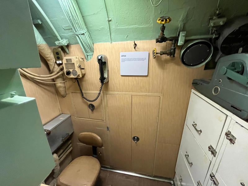 Yeomen handled clerical and administrative work aboard the USS Growler's tiny office. In the navigation compartment, crew members plotted courses and tracked Growler's position., The missile checkout and guidance center was once a top-secret area., Officers had access to their own shower., Officers used the wardroom to eat, socialize, and hold meetings., Yeomen handled clerical and administrative work aboard the USS Growler's tiny office., Here, the commanding officer would give orders to the crew., The sonar room also aided Growler's navigation., Crew members communicated with other ships in the radio room., Meals were prepared in the galley., In the scullery, Growler crew members washed dishes and compacted trash., The crew's mess was the only common space on the USS Growler., Growler's largest sleeping area contained 46 bunks., The crew's washroom featured two showers., Growler's three diesel engines were located in the engine room.