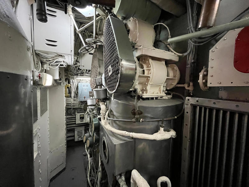 A distillation system boiled seawater, filtering out the salt to supply fresh water. In the navigation compartment, crew members plotted courses and tracked Growler's position., The missile checkout and guidance center was once a top-secret area., Officers had access to their own shower., Officers used the wardroom to eat, socialize, and hold meetings., Yeomen handled clerical and administrative work aboard the USS Growler's tiny office., Here, the commanding officer would give orders to the crew., The sonar room also aided Growler's navigation., Crew members communicated with other ships in the radio room., Meals were prepared in the galley., In the scullery, Growler crew members washed dishes and compacted trash., The crew's mess was the only common space on the USS Growler., Growler's largest sleeping area contained 46 bunks., The crew's washroom featured two showers., Growler's three diesel engines were located in the engine room.