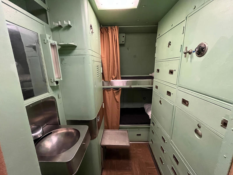 Officers on the USS Growler lived in staterooms that held two to three people. In the navigation compartment, crew members plotted courses and tracked Growler's position., The missile checkout and guidance center was once a top-secret area., Officers had access to their own shower., Officers used the wardroom to eat, socialize, and hold meetings., Yeomen handled clerical and administrative work aboard the USS Growler's tiny office., Here, the commanding officer would give orders to the crew., The sonar room also aided Growler's navigation., Crew members communicated with other ships in the radio room., Meals were prepared in the galley., In the scullery, Growler crew members washed dishes and compacted trash., The crew's mess was the only common space on the USS Growler., Growler's largest sleeping area contained 46 bunks., The crew's washroom featured two showers., Growler's three diesel engines were located in the engine room.