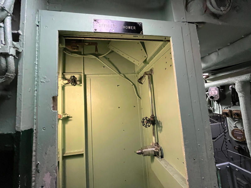 Officers had access to their own shower. In the navigation compartment, crew members plotted courses and tracked Growler's position., The missile checkout and guidance center was once a top-secret area., Officers had access to their own shower., Officers used the wardroom to eat, socialize, and hold meetings., Yeomen handled clerical and administrative work aboard the USS Growler's tiny office., Here, the commanding officer would give orders to the crew., The sonar room also aided Growler's navigation., Crew members communicated with other ships in the radio room., Meals were prepared in the galley., In the scullery, Growler crew members washed dishes and compacted trash., The crew's mess was the only common space on the USS Growler., Growler's largest sleeping area contained 46 bunks., The crew's washroom featured two showers., Growler's three diesel engines were located in the engine room.