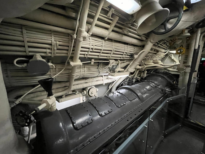 Growler's three diesel engines were located in the engine room. In the navigation compartment, crew members plotted courses and tracked Growler's position., The missile checkout and guidance center was once a top-secret area., Officers had access to their own shower., Officers used the wardroom to eat, socialize, and hold meetings., Yeomen handled clerical and administrative work aboard the USS Growler's tiny office., Here, the commanding officer would give orders to the crew., The sonar room also aided Growler's navigation., Crew members communicated with other ships in the radio room., Meals were prepared in the galley., In the scullery, Growler crew members washed dishes and compacted trash., The crew's mess was the only common space on the USS Growler., Growler's largest sleeping area contained 46 bunks., The crew's washroom featured two showers., Growler's three diesel engines were located in the engine room.