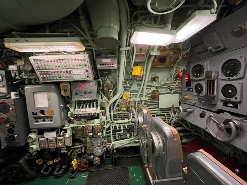 The control room and attack center contained a dizzying amount of buttons, dials, and other instruments. In the navigation compartment, crew members plotted courses and tracked Growler's position., The missile checkout and guidance center was once a top-secret area., Officers had access to their own shower., Officers used the wardroom to eat, socialize, and hold meetings., Yeomen handled clerical and administrative work aboard the USS Growler's tiny office., Here, the commanding officer would give orders to the crew., The sonar room also aided Growler's navigation., Crew members communicated with other ships in the radio room., Meals were prepared in the galley., In the scullery, Growler crew members washed dishes and compacted trash., The crew's mess was the only common space on the USS Growler., Growler's largest sleeping area contained 46 bunks., The crew's washroom featured two showers., Growler's three diesel engines were located in the engine room.