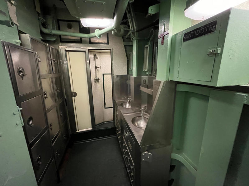 The crew's washroom featured two showers. In the navigation compartment, crew members plotted courses and tracked Growler's position., The missile checkout and guidance center was once a top-secret area., Officers had access to their own shower., Officers used the wardroom to eat, socialize, and hold meetings., Yeomen handled clerical and administrative work aboard the USS Growler's tiny office., Here, the commanding officer would give orders to the crew., The sonar room also aided Growler's navigation., Crew members communicated with other ships in the radio room., Meals were prepared in the galley., In the scullery, Growler crew members washed dishes and compacted trash., The crew's mess was the only common space on the USS Growler., Growler's largest sleeping area contained 46 bunks., The crew's washroom featured two showers., Growler's three diesel engines were located in the engine room.