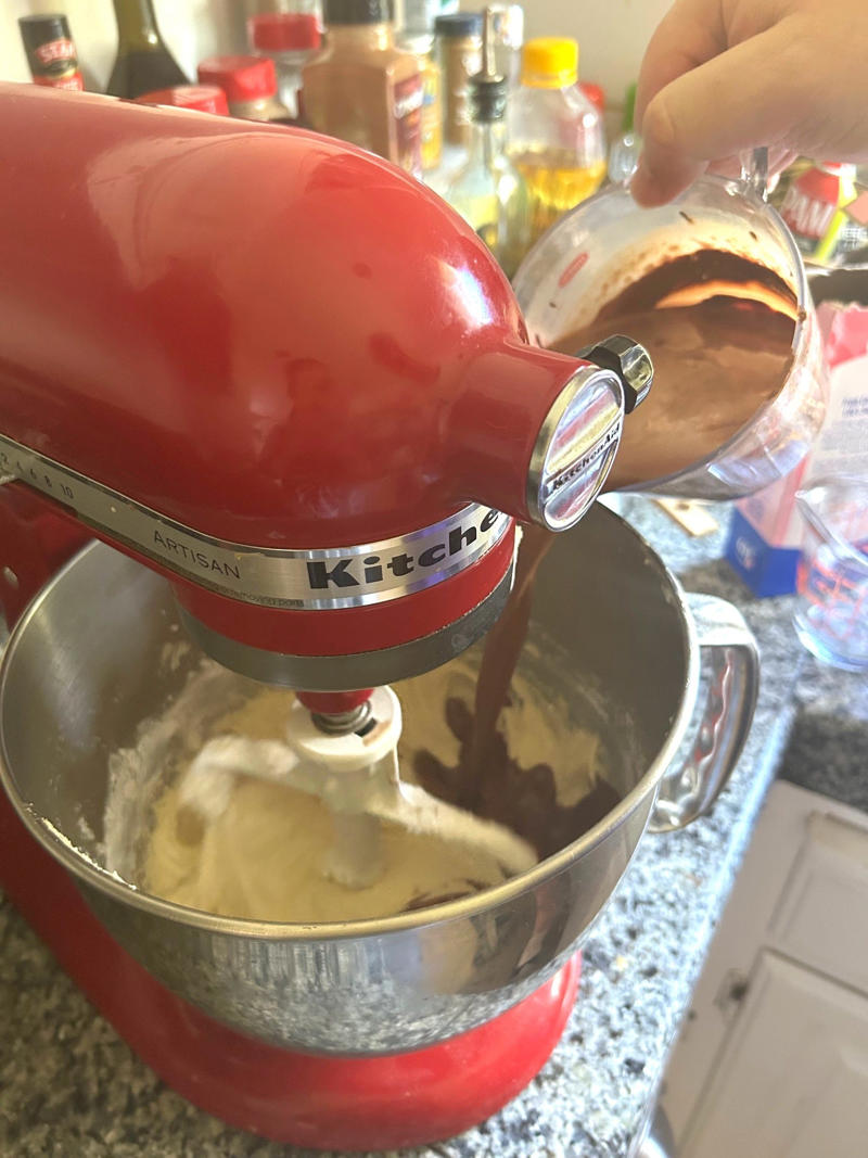 I turned my mixer to low and started adding my flour and chocolate mixtures. Garten's chocolate cake features cocoa powder, espresso powder, and "good" vanilla., You'll also need some ingredients for the mocha frosting., I also prepped my dry ingredients ..., … and my chocolate-and-coffee mixture., It was time to start the batter., Then I added the vanilla and eggs., My cake batter was ready!, While my cake was cooling, I began making the frosting., I also prepped the cream., Once the cream was ready, I poured it over the chocolate mixture., Then I stirred in the Kahlúa and vanilla., I covered my frosting and refrigerated it for 30 minutes., It was time to frost my cake., Garten's chocolate cake with mocha icing tasted rich and decadent.