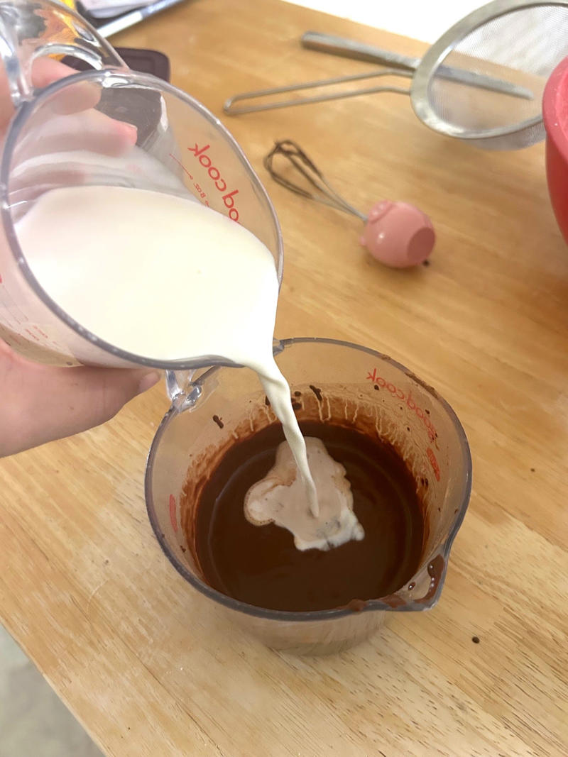 … and my chocolate-and-coffee mixture. Garten's chocolate cake features cocoa powder, espresso powder, and "good" vanilla., You'll also need some ingredients for the mocha frosting., I also prepped my dry ingredients ..., … and my chocolate-and-coffee mixture., It was time to start the batter., Then I added the vanilla and eggs., My cake batter was ready!, While my cake was cooling, I began making the frosting., I also prepped the cream., Once the cream was ready, I poured it over the chocolate mixture., Then I stirred in the Kahlúa and vanilla., I covered my frosting and refrigerated it for 30 minutes., It was time to frost my cake., Garten's chocolate cake with mocha icing tasted rich and decadent.