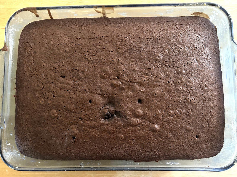 Once my cake was out of the oven, I let it cool completely in the pan. Garten's chocolate cake features cocoa powder, espresso powder, and "good" vanilla., You'll also need some ingredients for the mocha frosting., I also prepped my dry ingredients ..., … and my chocolate-and-coffee mixture., It was time to start the batter., Then I added the vanilla and eggs., My cake batter was ready!, While my cake was cooling, I began making the frosting., I also prepped the cream., Once the cream was ready, I poured it over the chocolate mixture., Then I stirred in the Kahlúa and vanilla., I covered my frosting and refrigerated it for 30 minutes., It was time to frost my cake., Garten's chocolate cake with mocha icing tasted rich and decadent.