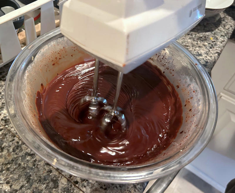 Once it had chilled, I scraped down the bowl and beat the frosting with a handheld mixer. Garten's chocolate cake features cocoa powder, espresso powder, and "good" vanilla., You'll also need some ingredients for the mocha frosting., I also prepped my dry ingredients ..., … and my chocolate-and-coffee mixture., It was time to start the batter., Then I added the vanilla and eggs., My cake batter was ready!, While my cake was cooling, I began making the frosting., I also prepped the cream., Once the cream was ready, I poured it over the chocolate mixture., Then I stirred in the Kahlúa and vanilla., I covered my frosting and refrigerated it for 30 minutes., It was time to frost my cake., Garten's chocolate cake with mocha icing tasted rich and decadent.