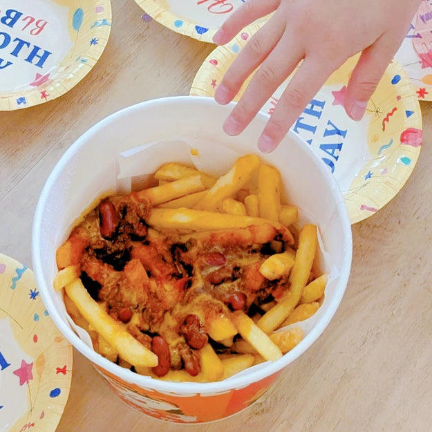 バケツのような大きな容器に、4袋分のポテトがぎっしり！, チリソースとチーズがかかっていて、やみつきになる味。, パーティーで、ママにも子どもにも大好評！, フォークが入っているのも、ありがたい！