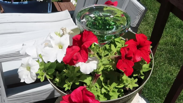 Repurpose found objects, Make use of a tree stump, Build an in ground pool, Suspend baths from low hanging branches, Upcycle an old sink, Pop a margarita glass into your planter, Repurpose an old ice cream parlor chair, Transform candlesticks or vintage lamps, Give new life to a galvanized wash tub