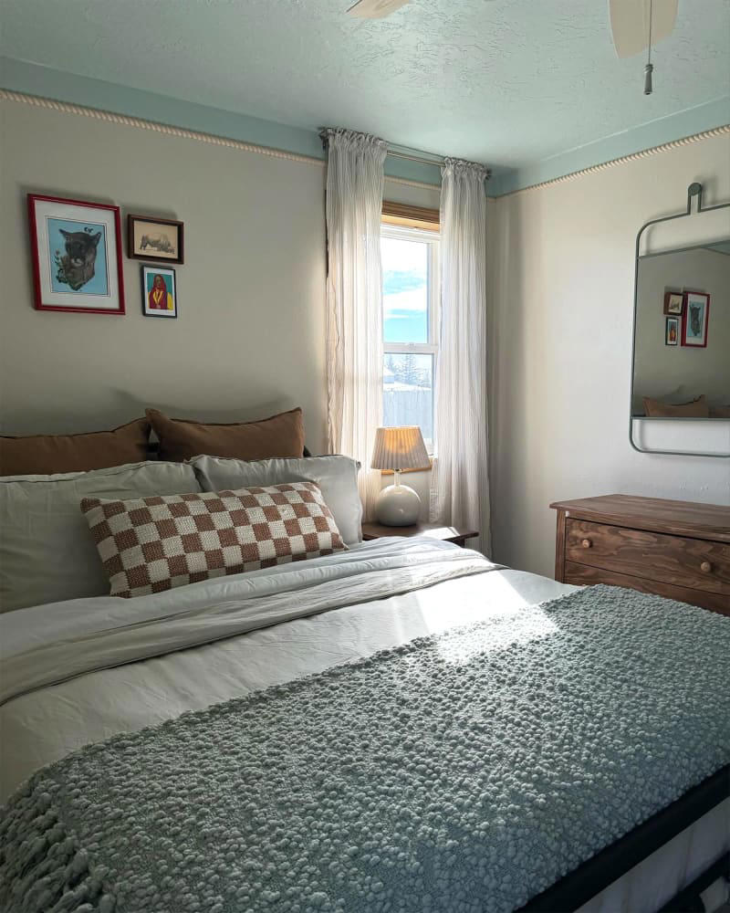A budget-friendly flooring upgrade ditches the run-down feel., The walls, ceiling, and trim got fresh paint., Rope-style trim adds budget-friendly character., Secondhand finds (plus some fun new items) add the finishing touches.