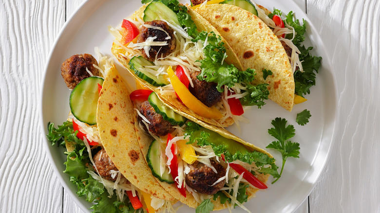 1. Cook them in grape jelly for a sweet and savory snack, 2. Stuff frozen meatballs into a sandwich, 3. Use frozen meatballs as taco filling, 4. Combine them with pineapple and peppers for a sweet and sour dish, 5. Serve frozen meatballs with gravy on top of mashed potatoes, 6. Pile them onto a pizza, 7. Add frozen meatballs to veggie soup to bulk up the dish, 8. Air fry meatballs for a crispy bite, 9. Make bite-sized sliders for your next party, 10. Bake frozen meatballs into a casserole for a hearty dinner, 11. Stuff the meatballs in pasta shells, 12. Cook them in a curry sauce to maximize flavor, 13. Add them to French onion soup