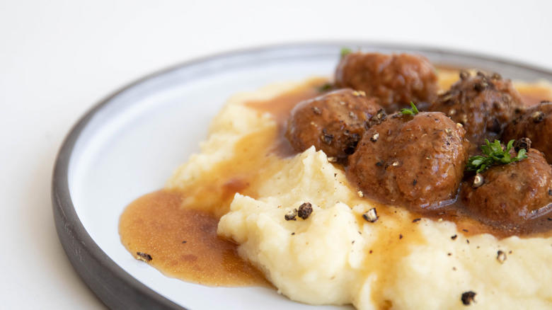 1. Cook them in grape jelly for a sweet and savory snack, 2. Stuff frozen meatballs into a sandwich, 3. Use frozen meatballs as taco filling, 4. Combine them with pineapple and peppers for a sweet and sour dish, 5. Serve frozen meatballs with gravy on top of mashed potatoes, 6. Pile them onto a pizza, 7. Add frozen meatballs to veggie soup to bulk up the dish, 8. Air fry meatballs for a crispy bite, 9. Make bite-sized sliders for your next party, 10. Bake frozen meatballs into a casserole for a hearty dinner, 11. Stuff the meatballs in pasta shells, 12. Cook them in a curry sauce to maximize flavor, 13. Add them to French onion soup